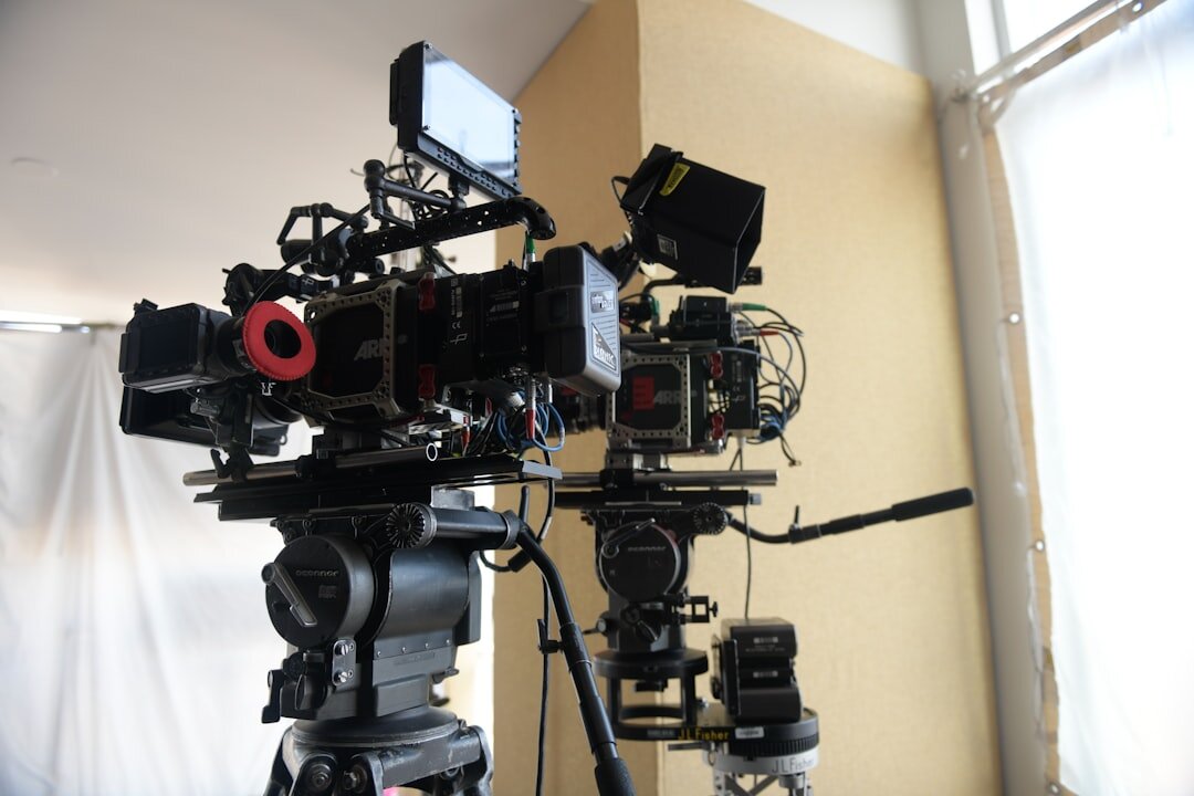 Television studio set with multiple broadcast cameras positioned around a presenter desk