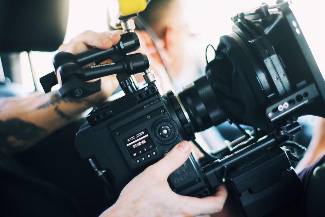 Professional camera operator holding a broadcast television camera