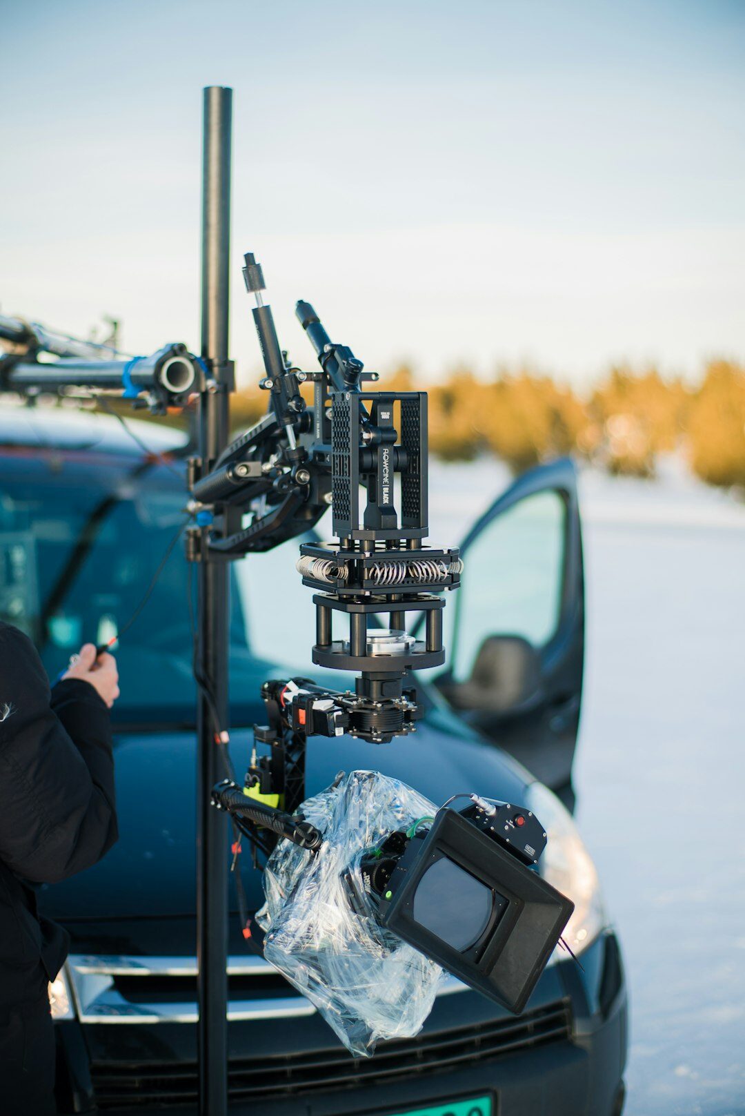 Outside broadcast van with camera crew setting up equipment for a live report